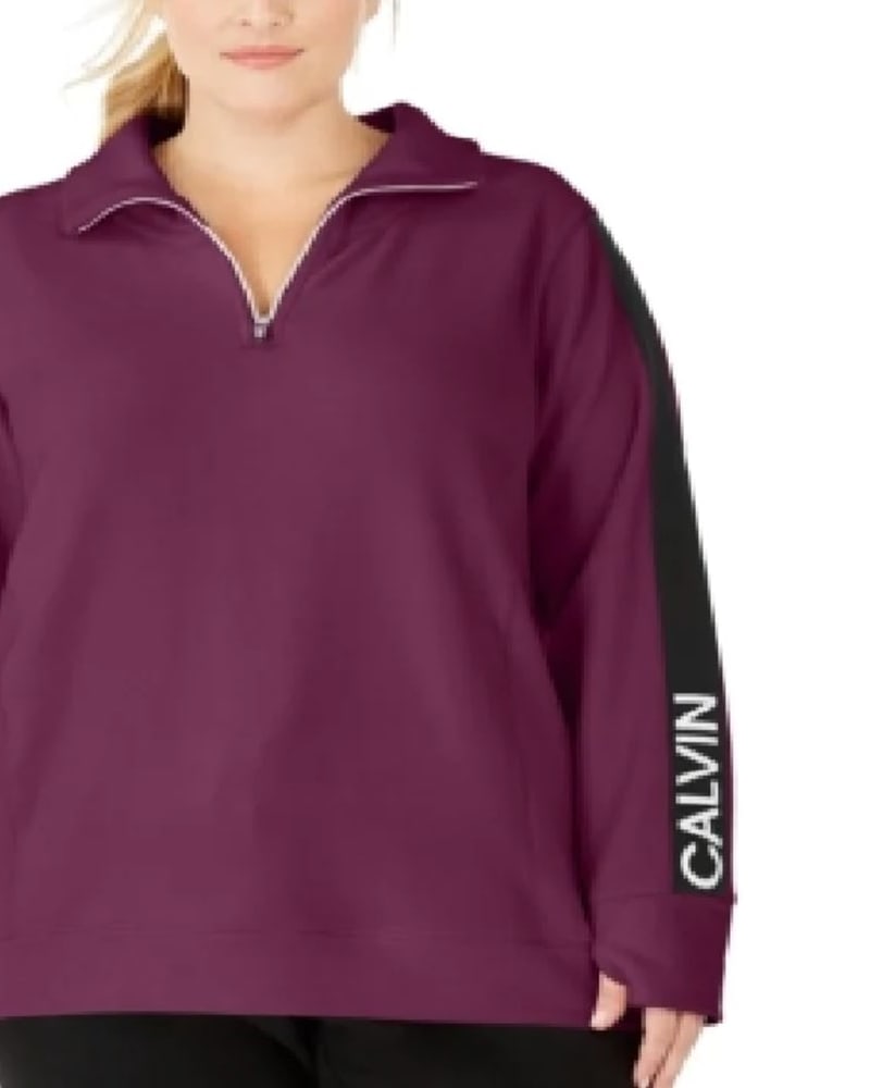 Front of a model wearing a size 1X Calvin Klein Women's Performance Plus Logo Sleeve Zip Neck Top Purple Size 1X in Purple by Calvin Klein. | dia_product_style_image_id:311051